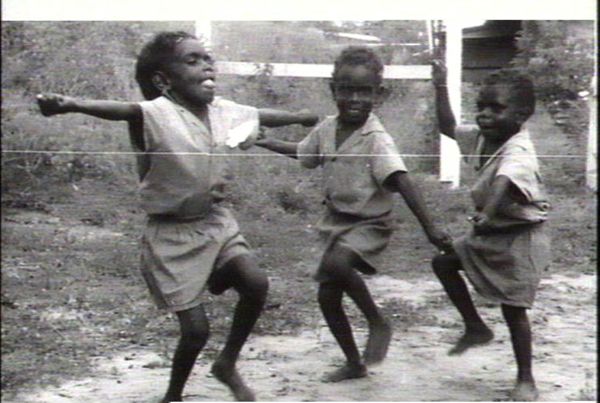 Three aboriginal boys "dancing"